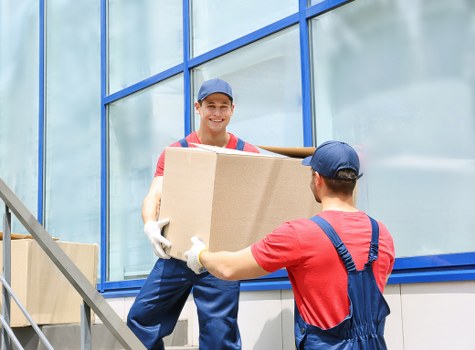 Commercial movers placing office items in a new Soho workspace after relocation