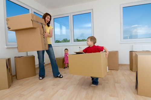 Removal team carrying furniture through a central London apartment building