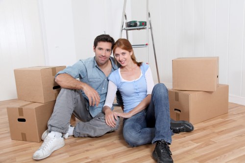 Professional movers carrying furniture through a central London building
